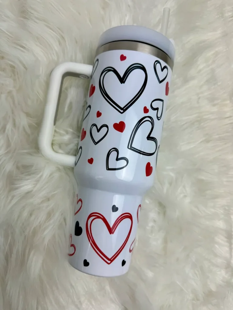 A white cup with hearts on it