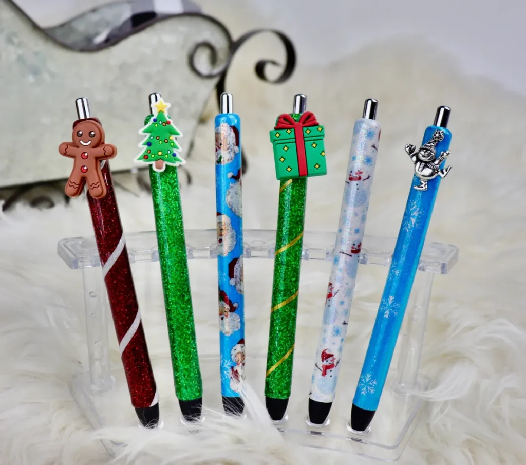 A set of six pens with christmas designs on them.
