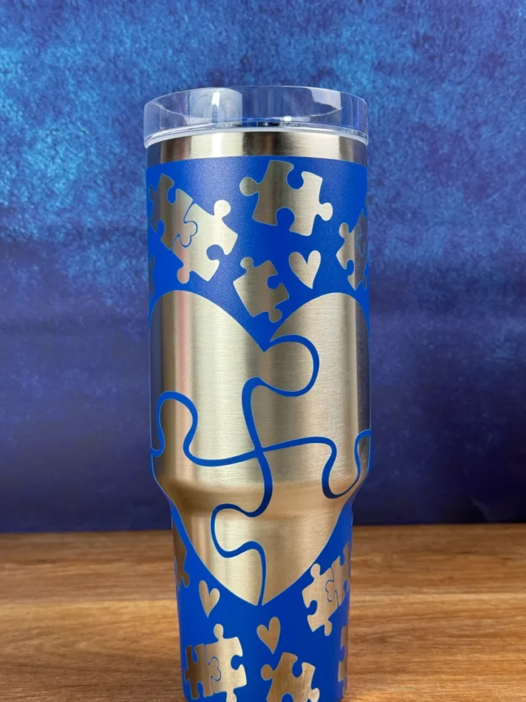 A blue and gold puzzle piece travel mug.