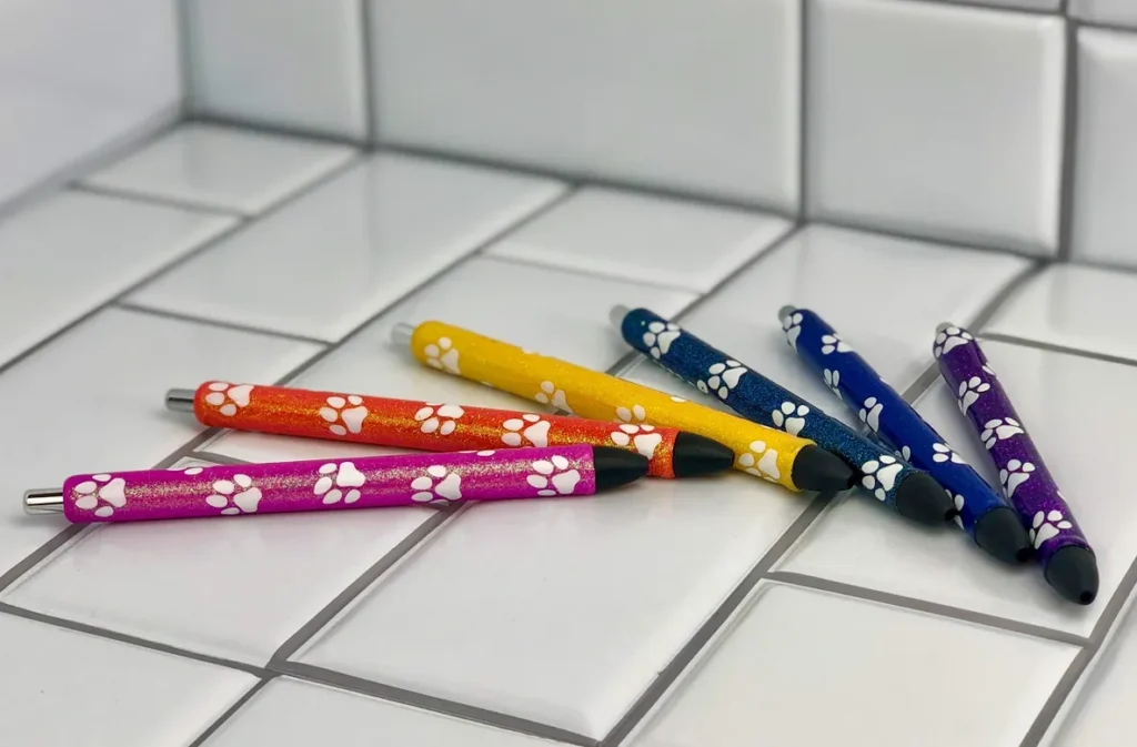 A group of pencils with paw prints on them.
