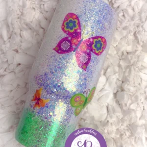 A close up of a candle with butterflies on it