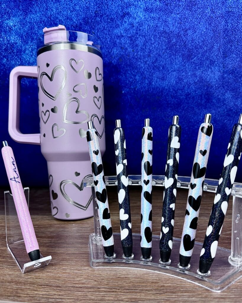 Pink tumbler and decorative heart pens.