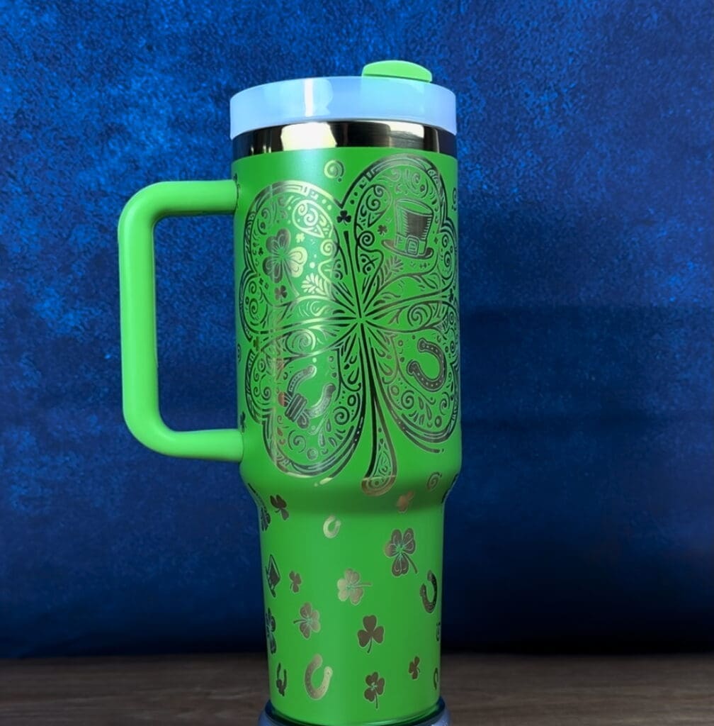 Green mug with shamrock and festive designs.