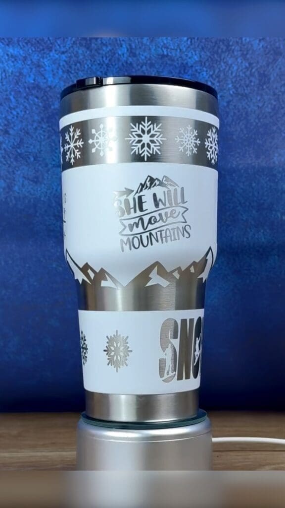 Insulated travel mug with mountain design.