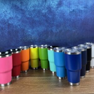 Colorful tumblers arranged on a wooden surface.