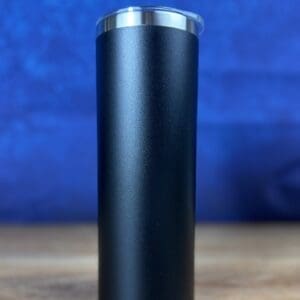 Black insulated tumbler against a blue background.