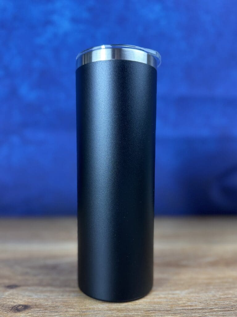 Black insulated tumbler against a blue background.