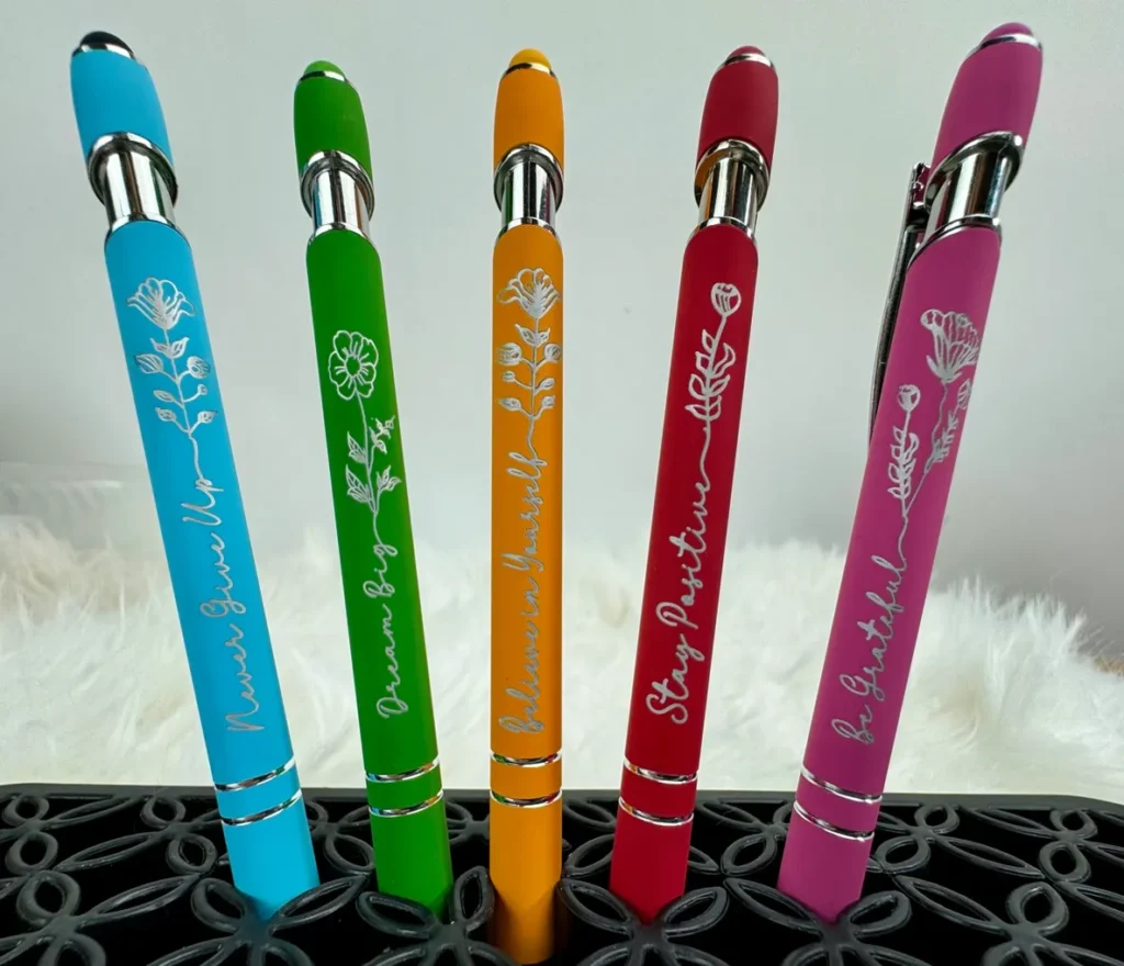Colorful motivational pens in a holder.