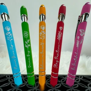 Colorful motivational pens in a holder.