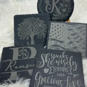Decorative slate coasters with various designs.