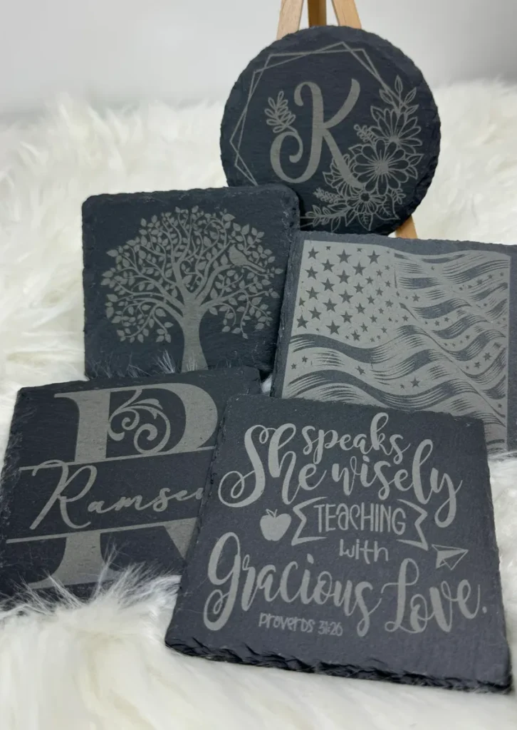Decorative slate coasters with various designs.