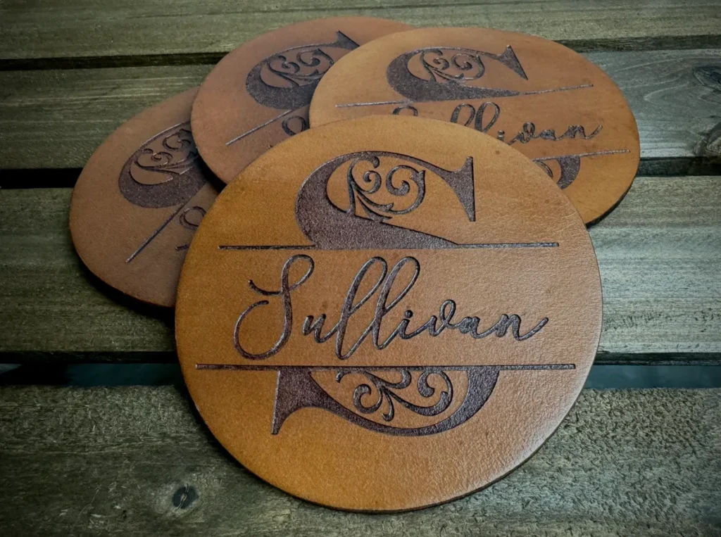Personalized leather coasters with decorative design.