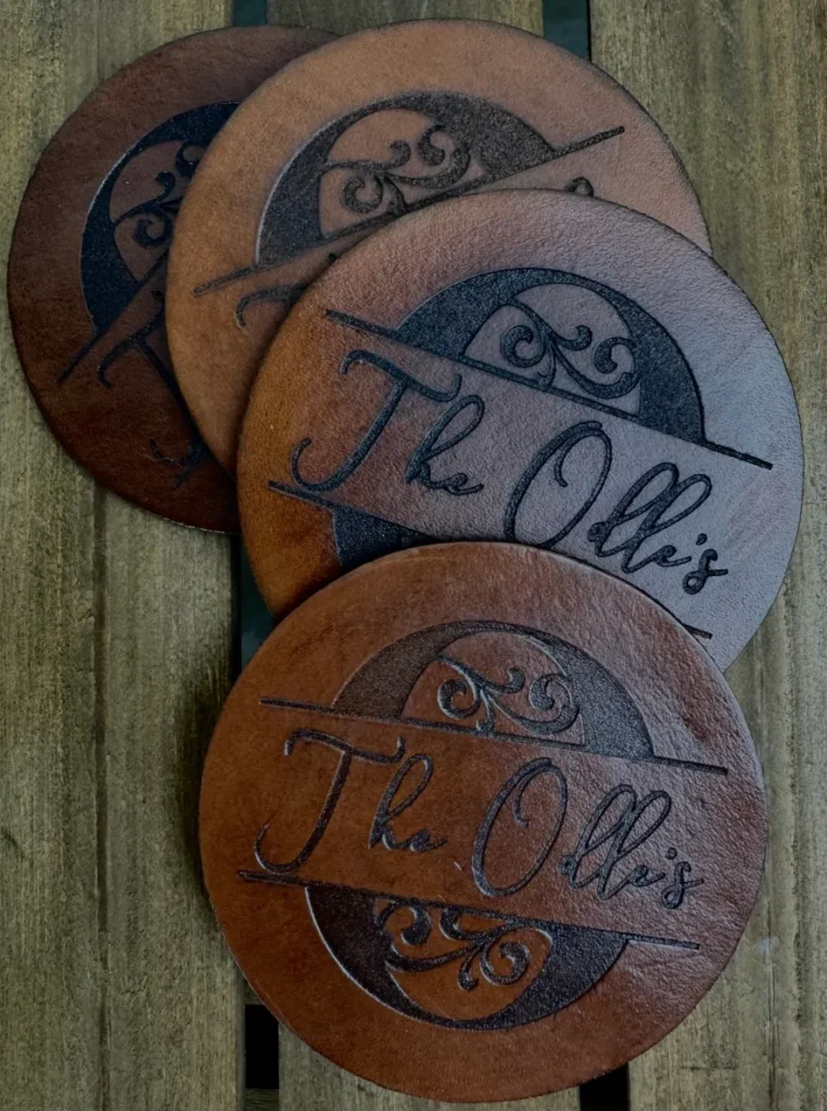 Brown coasters with "The Ott's" engraved design.