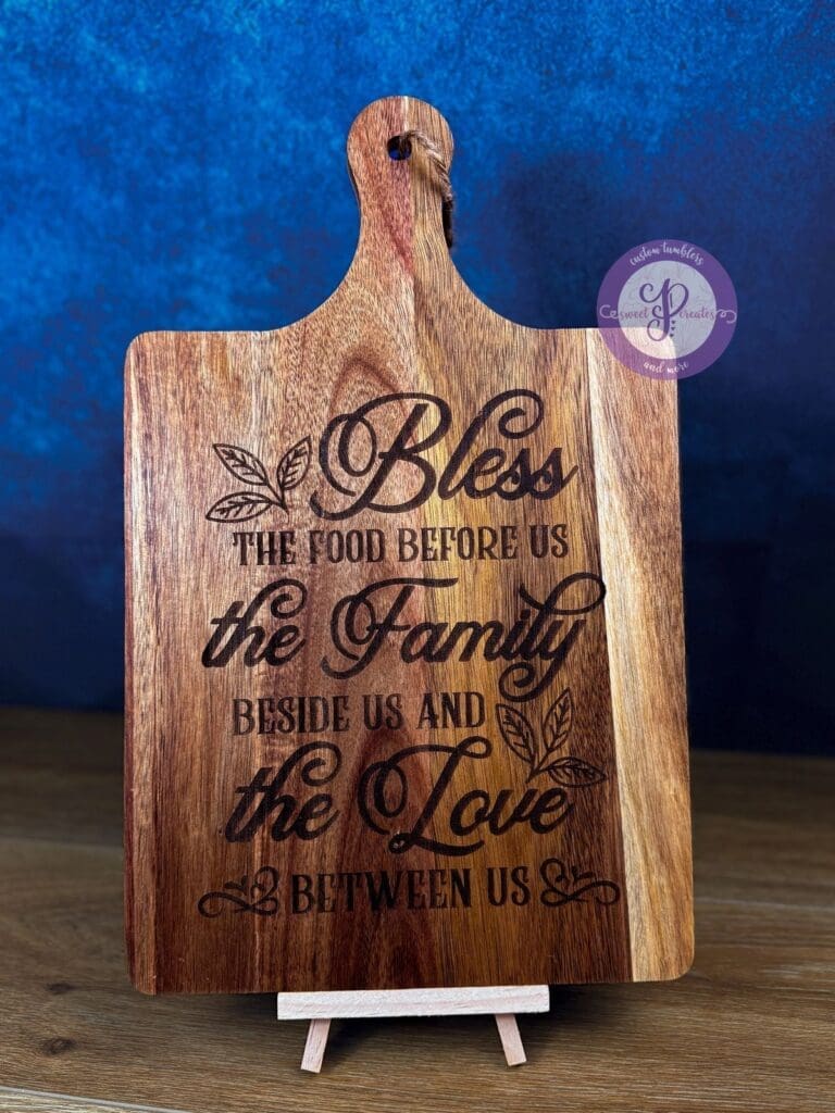 Wooden cutting board with heartfelt blessing text.