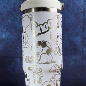 Snoopy-themed insulated cup with handle.