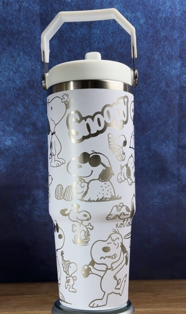 Snoopy-themed insulated cup with handle.