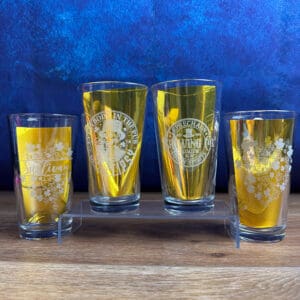 Assorted glasses with yellow liquid displayed.