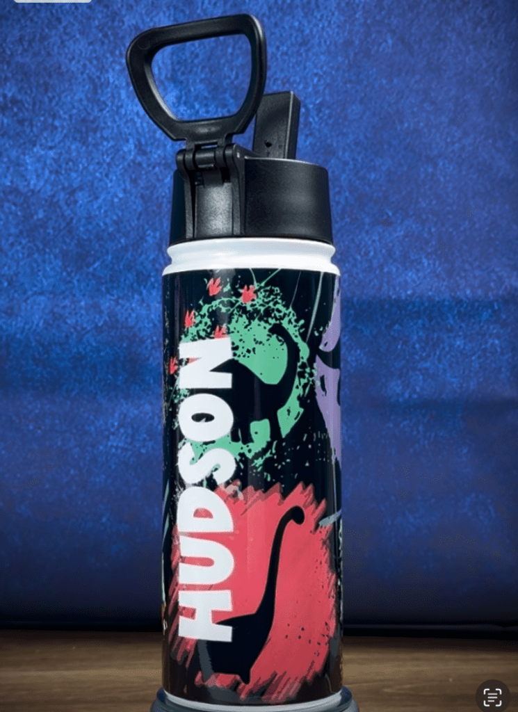 Colorful water bottle with dinosaur design.