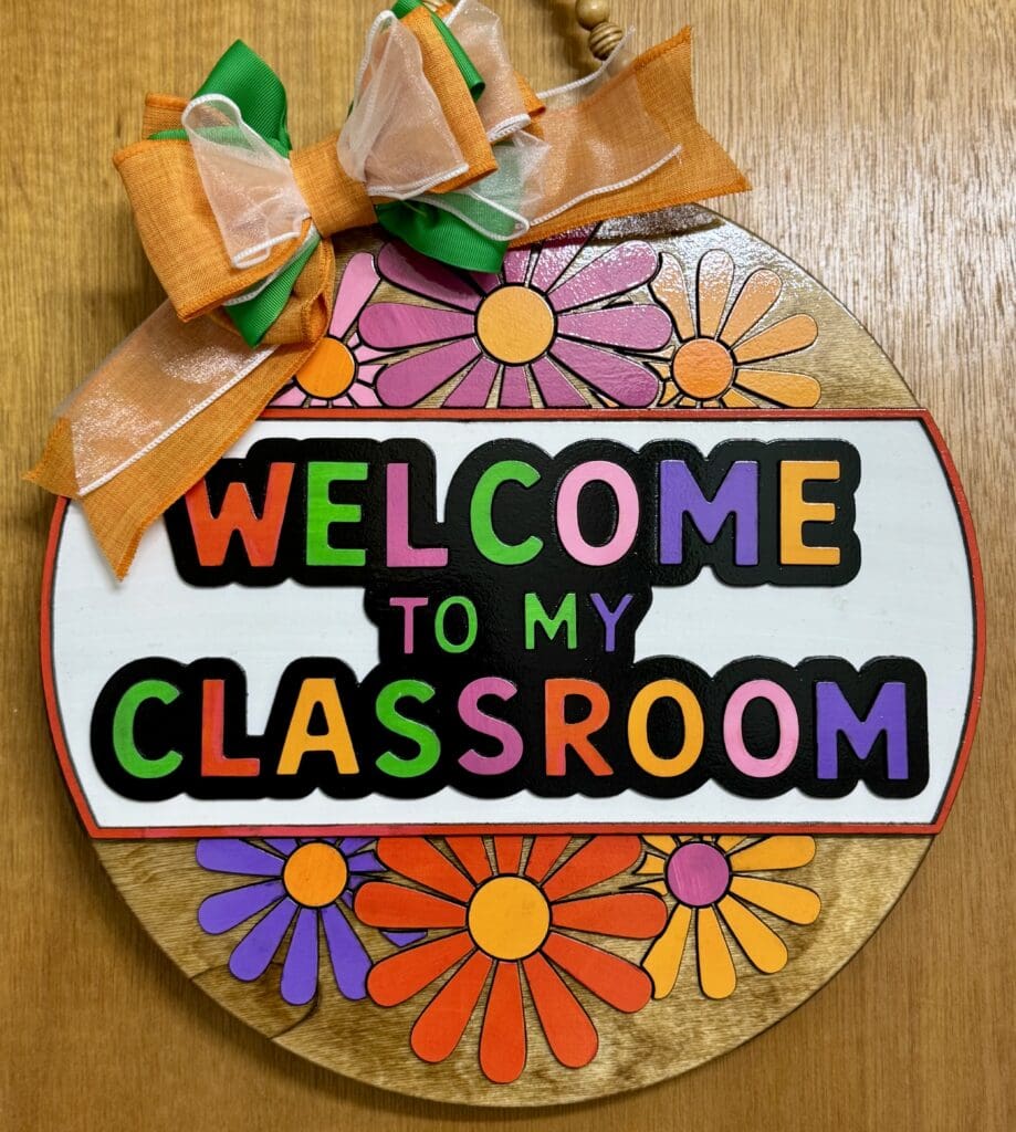 Colorful classroom welcome sign with flowers.