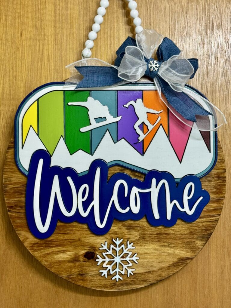 Colorful snowboard-themed welcome door hanger