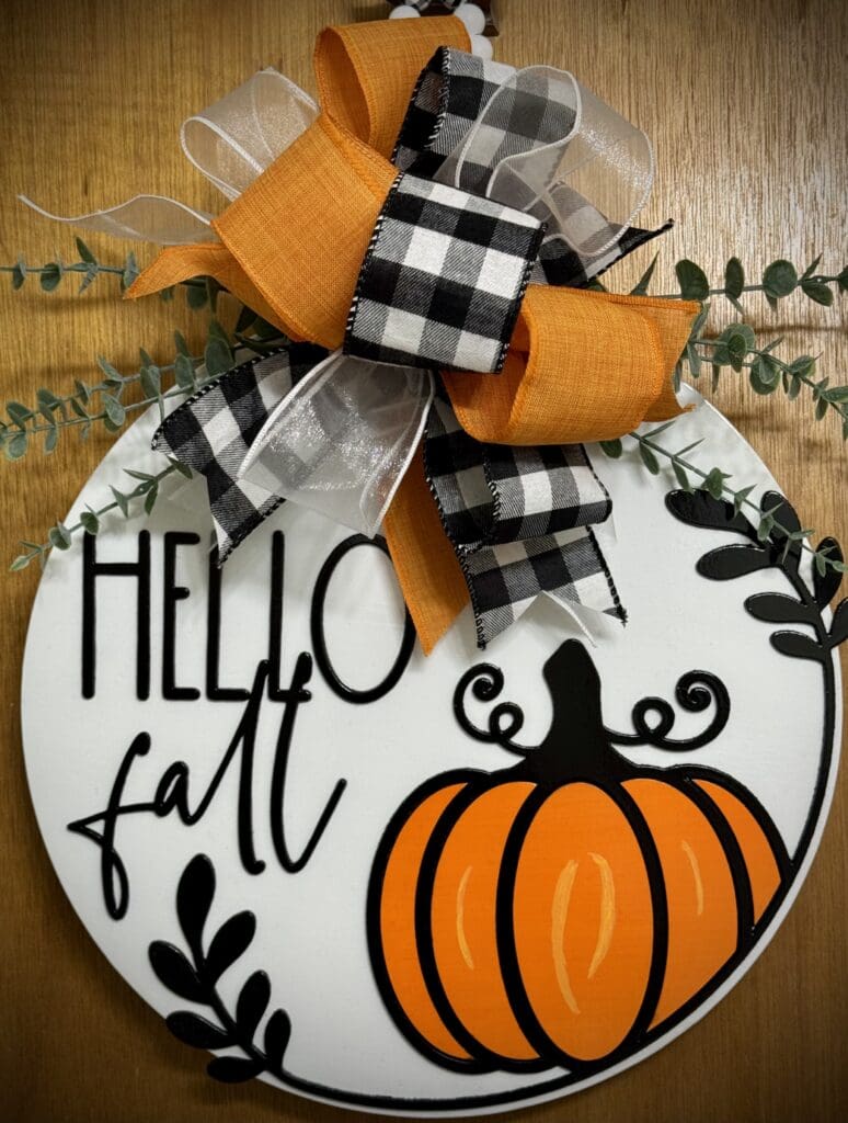 Decorative fall sign with pumpkin design.