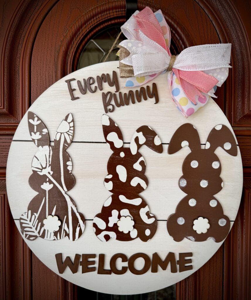 Wooden welcome sign with bunny silhouettes.