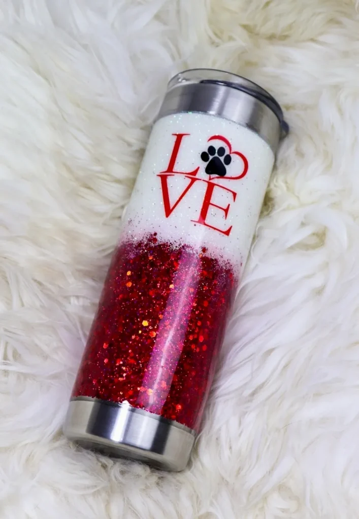 Glittery cup with "LOVE" design and paw print.