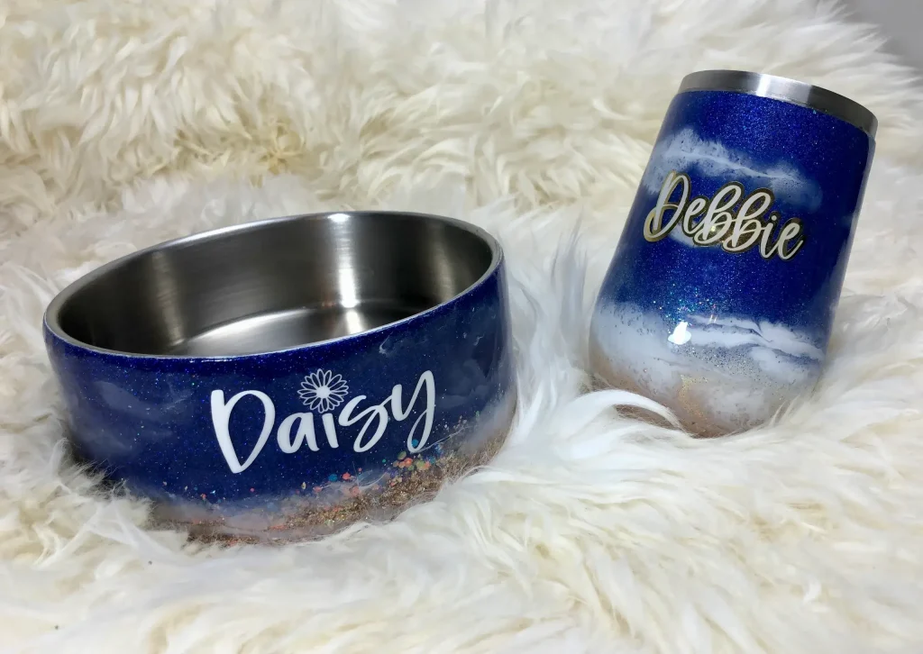 Personalized pet bowl and tumbler on fur.
