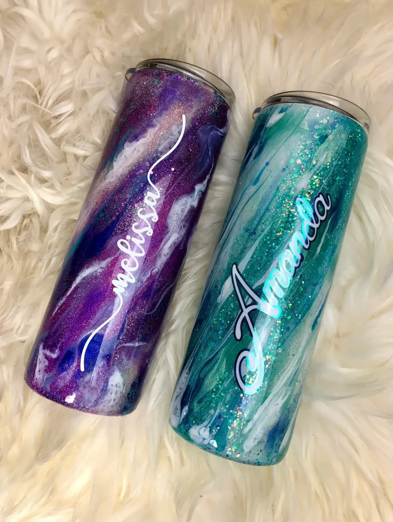 Personalized colorful tumblers on fluffy background.