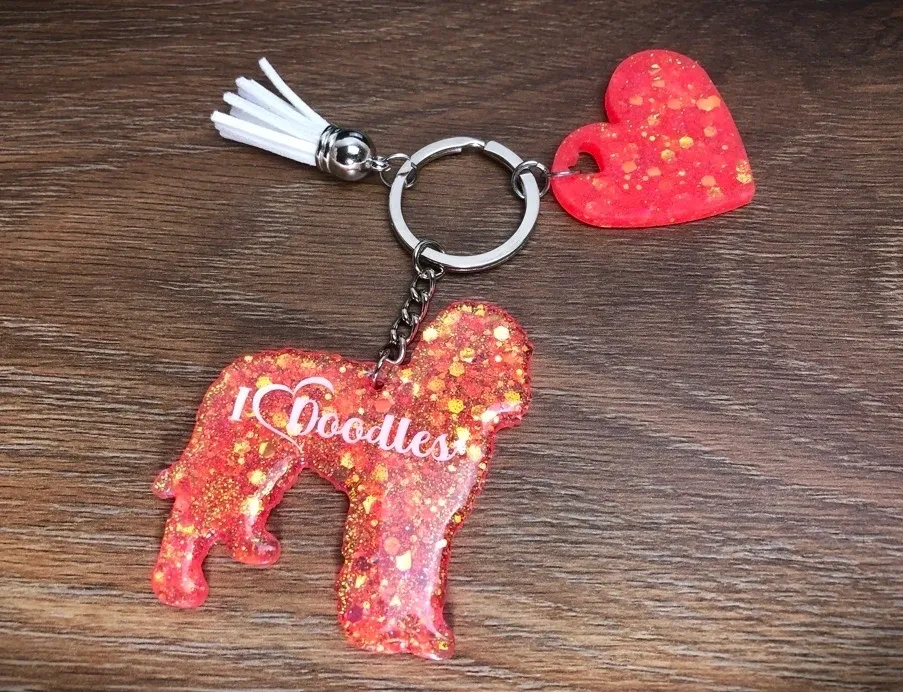 Keychain with red dog and heart charms.