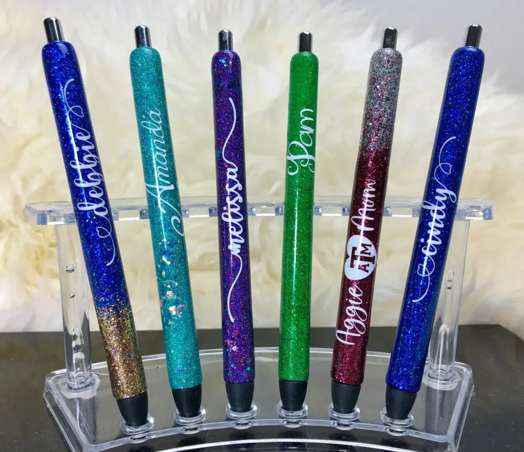 Colorful glitter pens displayed on a stand.